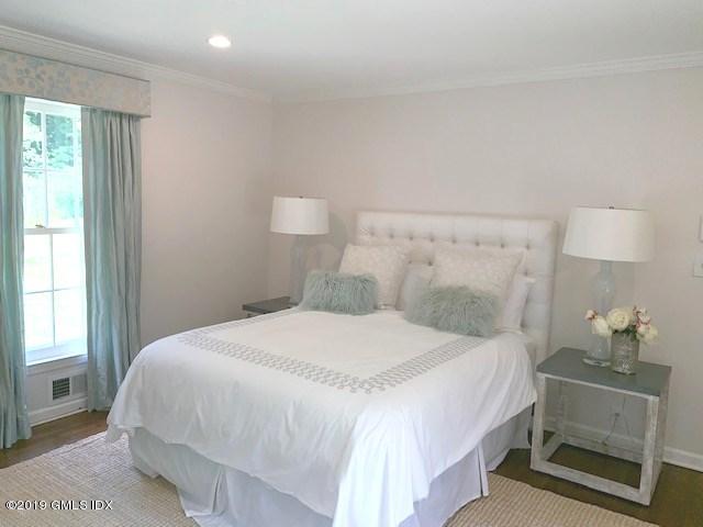 244 Stanwich Road Greenwich, CT 06830 - Photo 16 of 22 a bedroom with a bed and a lamp