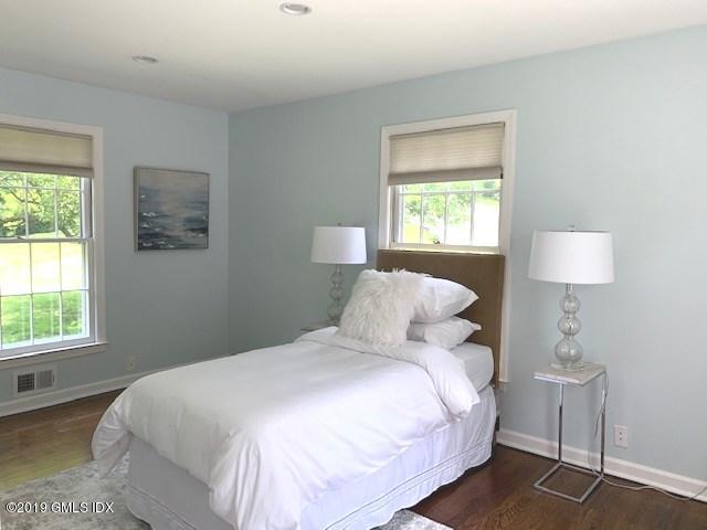244 Stanwich Road Greenwich, CT 06830 - Photo 19 of 22 a bedroom with a bed and a lamp