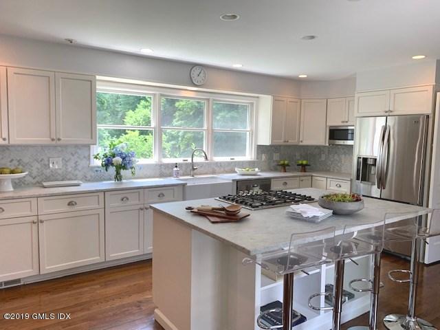244 Stanwich Road Greenwich, CT 06830 - Photo 3 of 22 a kitchen with stainless steel appliances granite countertop a stove a sink a refrigerator white cabinets and wooden floor