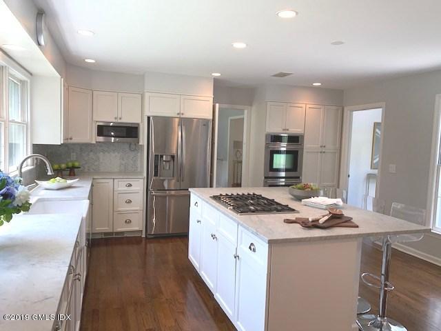 244 Stanwich Road Greenwich, CT 06830 - Photo 4 of 22 a kitchen with stainless steel appliances granite countertop a sink stove and refrigerator
