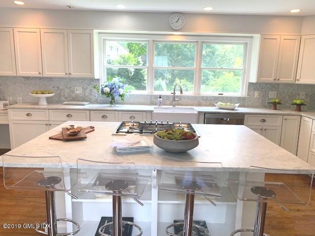 244 Stanwich Road Greenwich, CT 06830 - Photo 6 of 22 a kitchen with a stove a sink and a white wooden cabinets