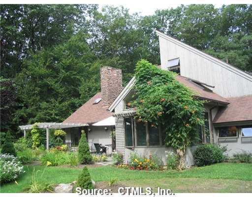 283 Norfolk Road Litchfield, CT 06759 - Photo 1 of 1 a aerial view of a house with yard and trees in the background