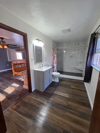 a view of a room with wooden floor and stairs