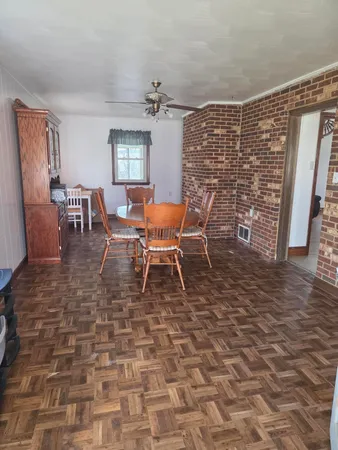 a dining room with furniture and wooden floor
