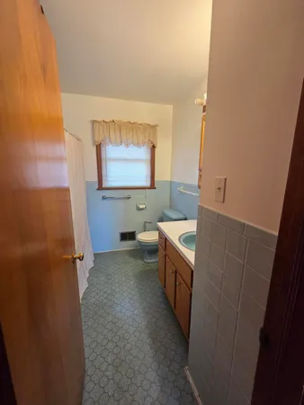 a bathroom with sink mirror vanity and toilet