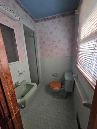 a bathroom with a toilet and a sink