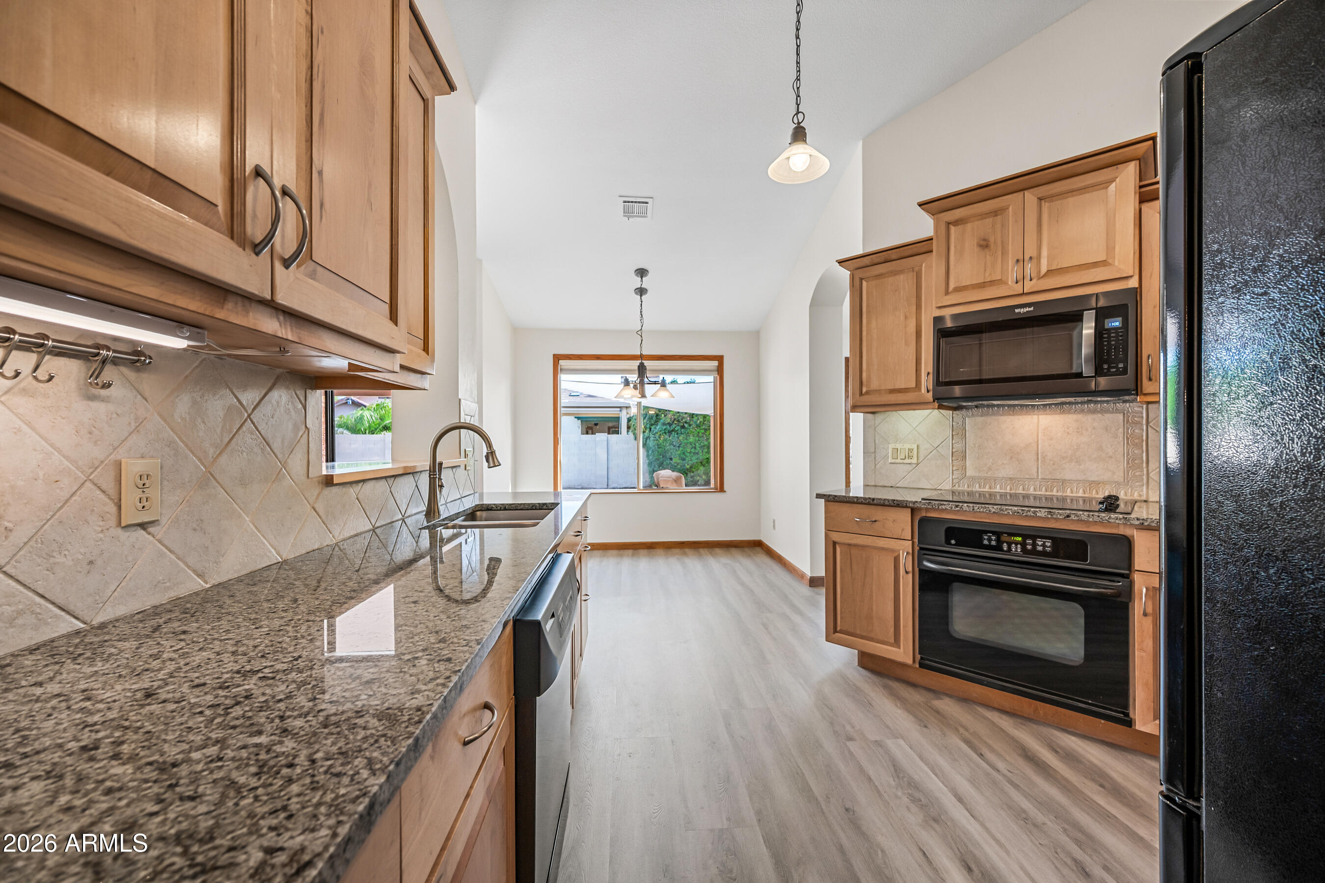 7833 South Terrace Road Tempe, AZ 85284 - Photo 9 of 39 a kitchen with granite countertop a stove top oven and sink
