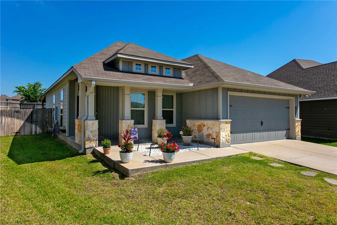 2071 Positano Loop Bryan, TX 77808 - Photo 3 of 31 a front view of a house with garden and patio