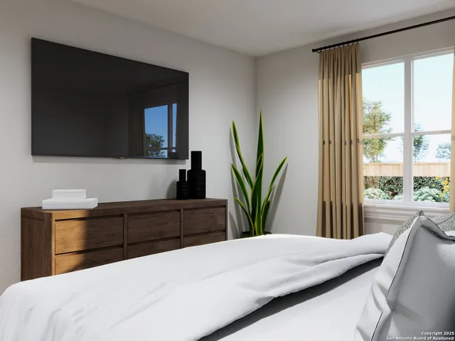 a bedroom with a bed and a television