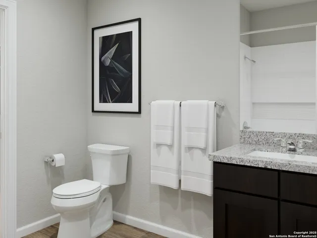 a bathroom with a toilet sink and shower
