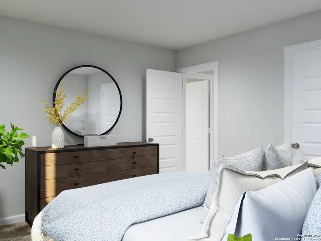 a living room with a mirror a couch and a potted plant