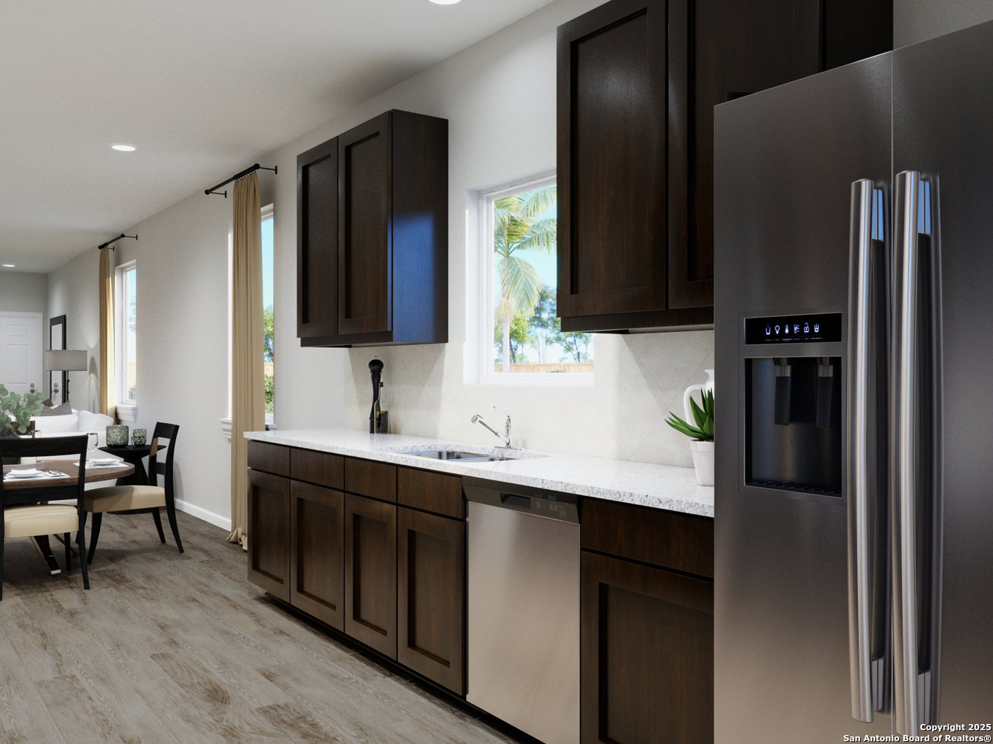 11107 Luckenbach Loop Converse, TX 78109 - Photo 9 of 25 a kitchen with stainless steel appliances a sink and a refrigerator