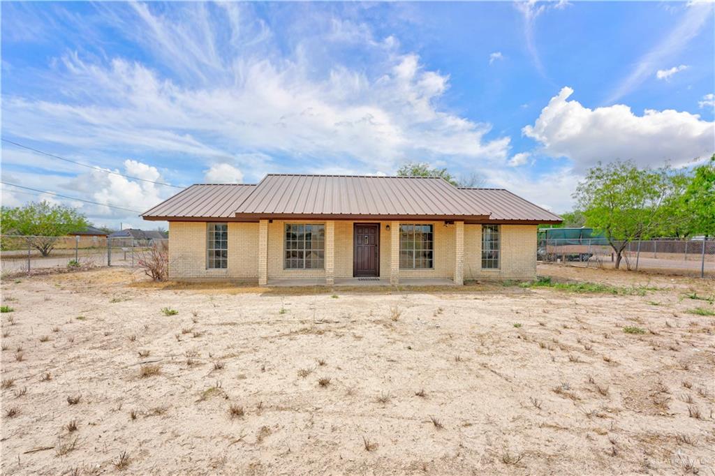 3101 Tom Gill Road Penitas, TX 78576 - Photo 2 of 16 a front view of a house with a yard