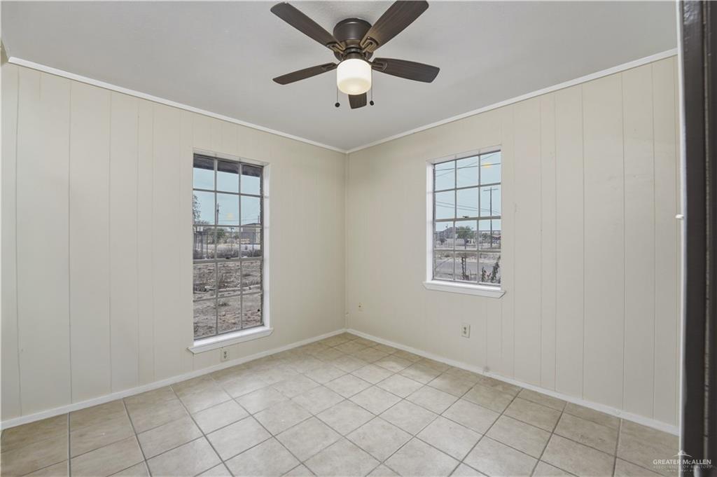 3101 Tom Gill Road Penitas, TX 78576 - Photo 8 of 16 an empty room with windows and fan