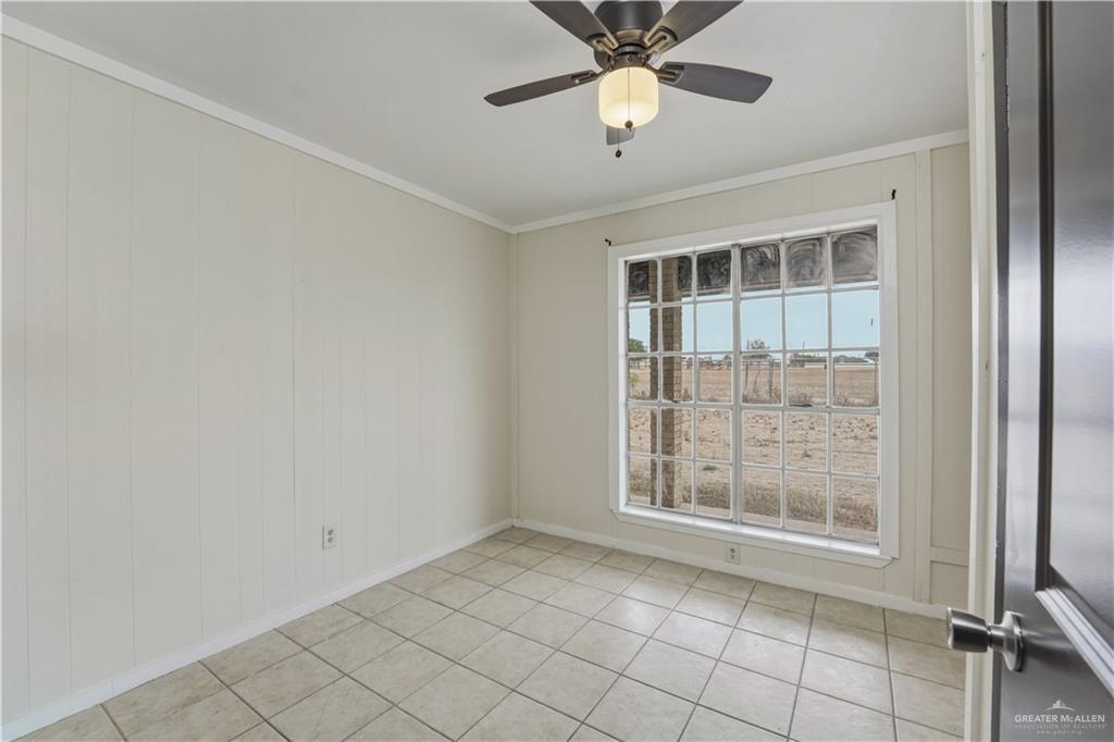 3101 Tom Gill Road Penitas, TX 78576 - Photo 10 of 16 an empty room with windows and fan