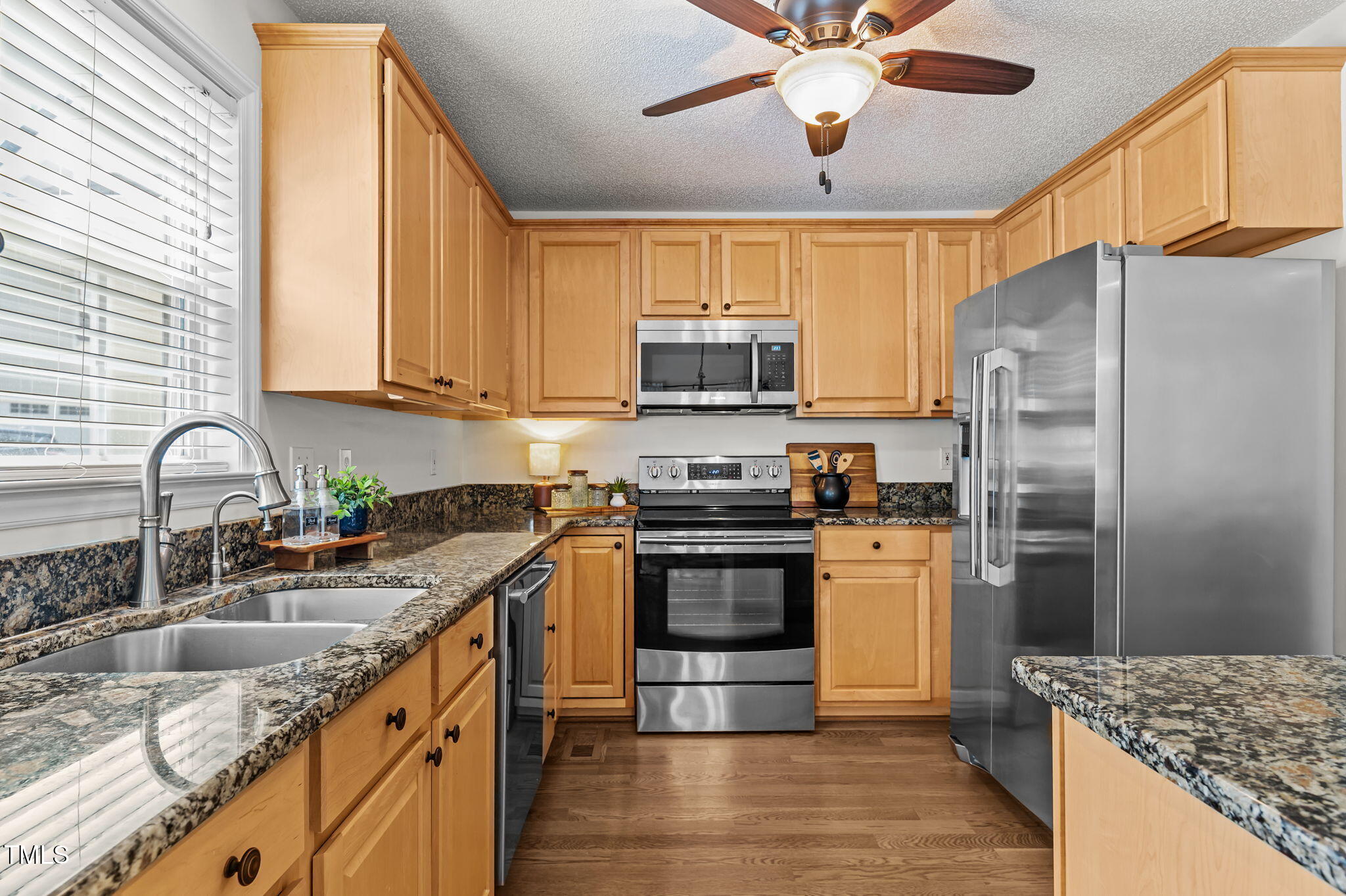 11924 Larka Court Raleigh, NC 27613 - Photo 13 of 44 a kitchen with stainless steel appliances granite countertop a sink stove and refrigerator