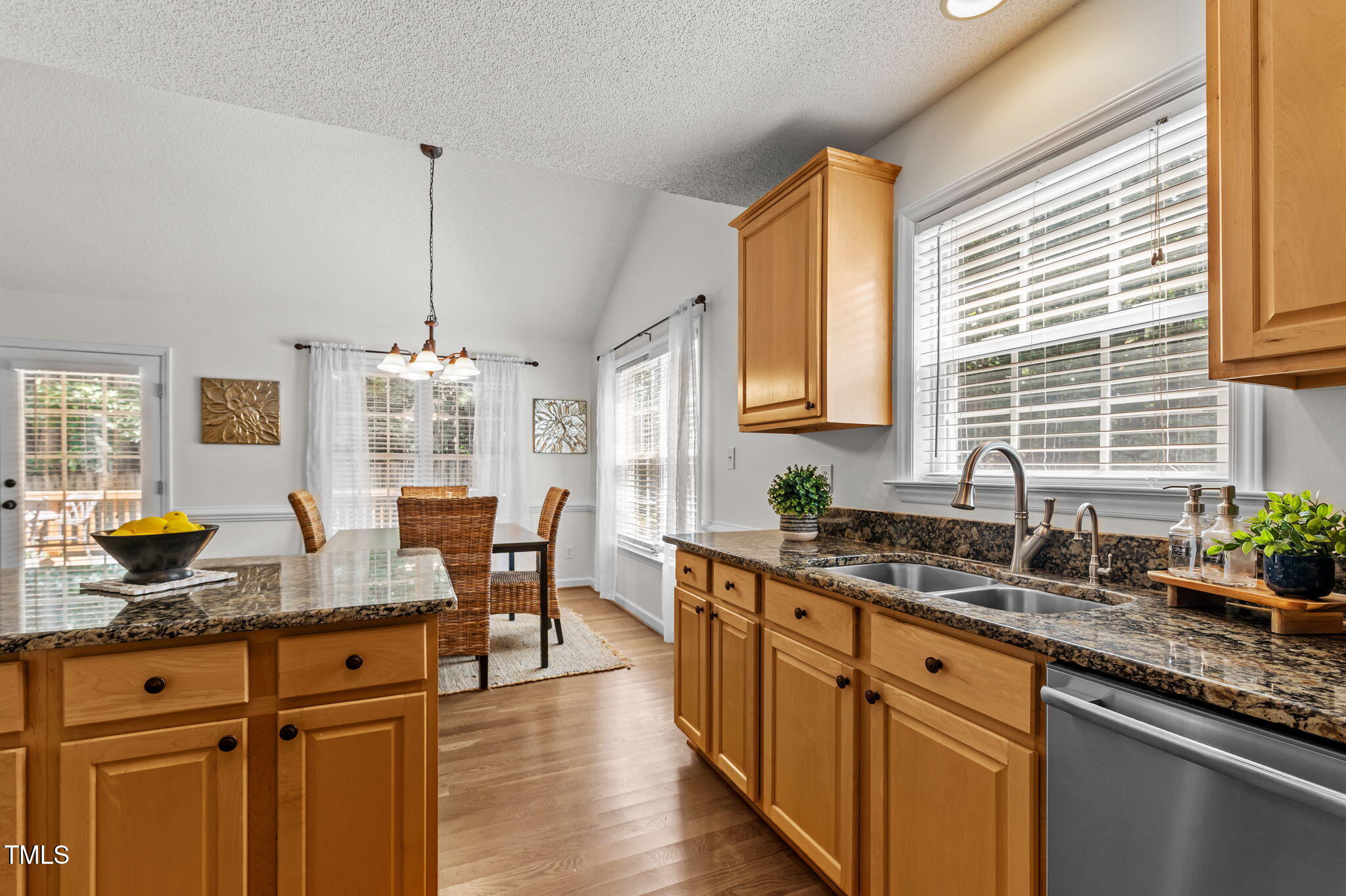 11924 Larka Court Raleigh, NC 27613 - Photo 14 of 44 a kitchen with stainless steel appliances granite countertop a sink a stove and a wooden floors