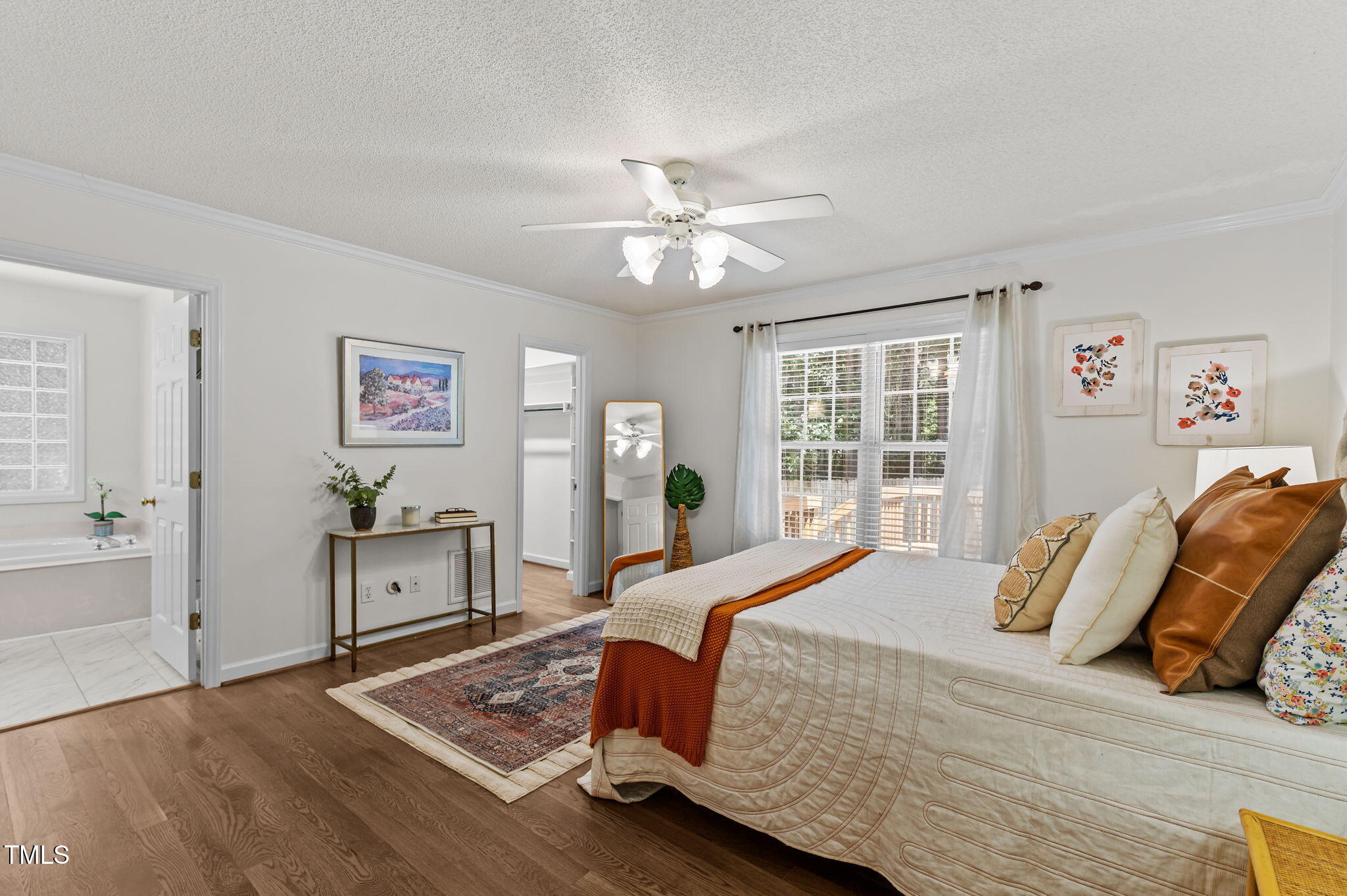 11924 Larka Court Raleigh, NC 27613 - Photo 16 of 44 a bedroom with a bed and a chandelier