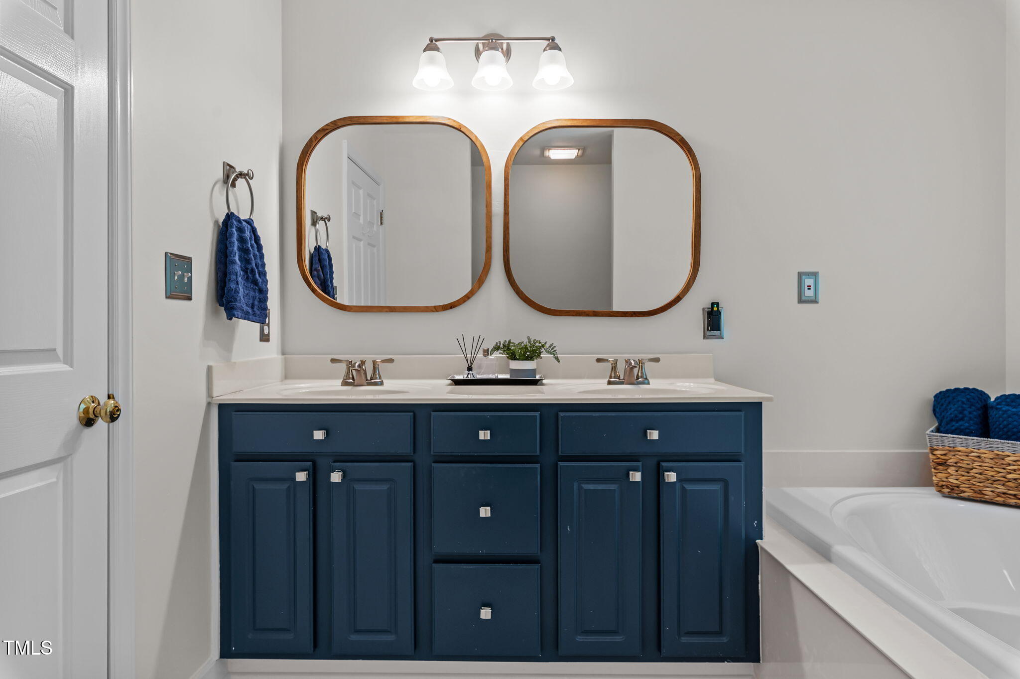 11924 Larka Court Raleigh, NC 27613 - Photo 18 of 44 a bathroom with a double vanity sink and a mirror