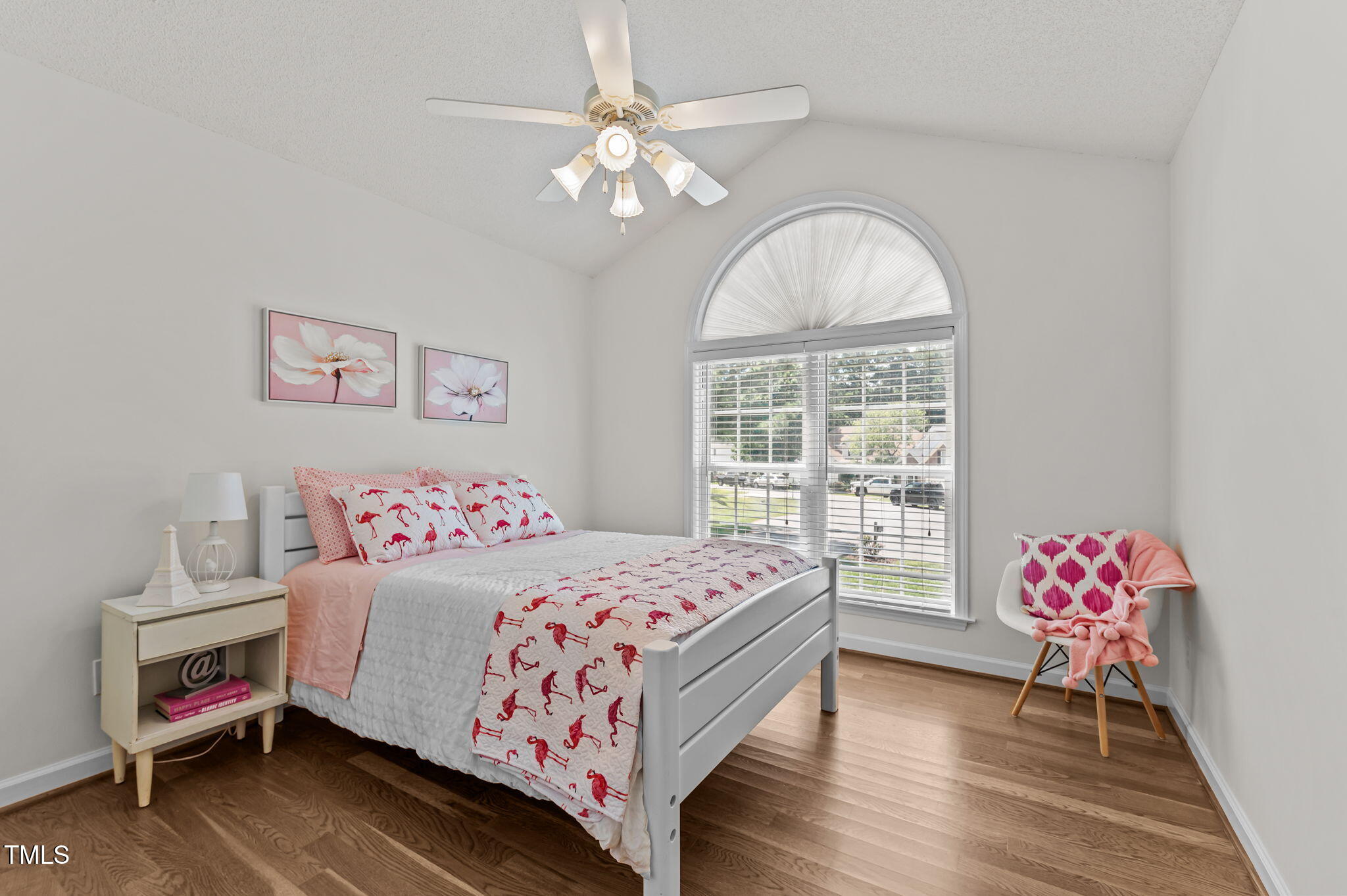 11924 Larka Court Raleigh, NC 27613 - Photo 22 of 44 a bedroom with a bed and a chandelier