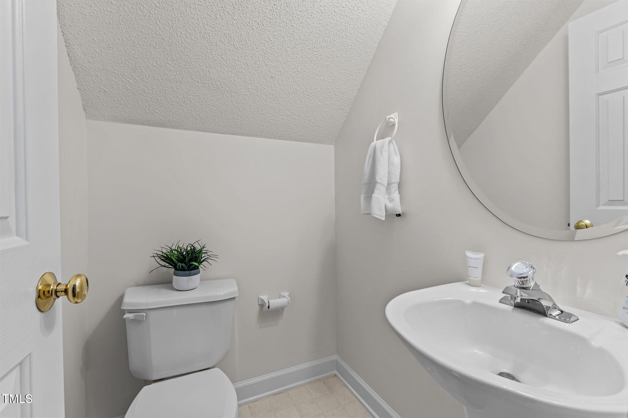 11924 Larka Court Raleigh, NC 27613 - Photo 29 of 44 a bathroom with a toilet sink and mirror