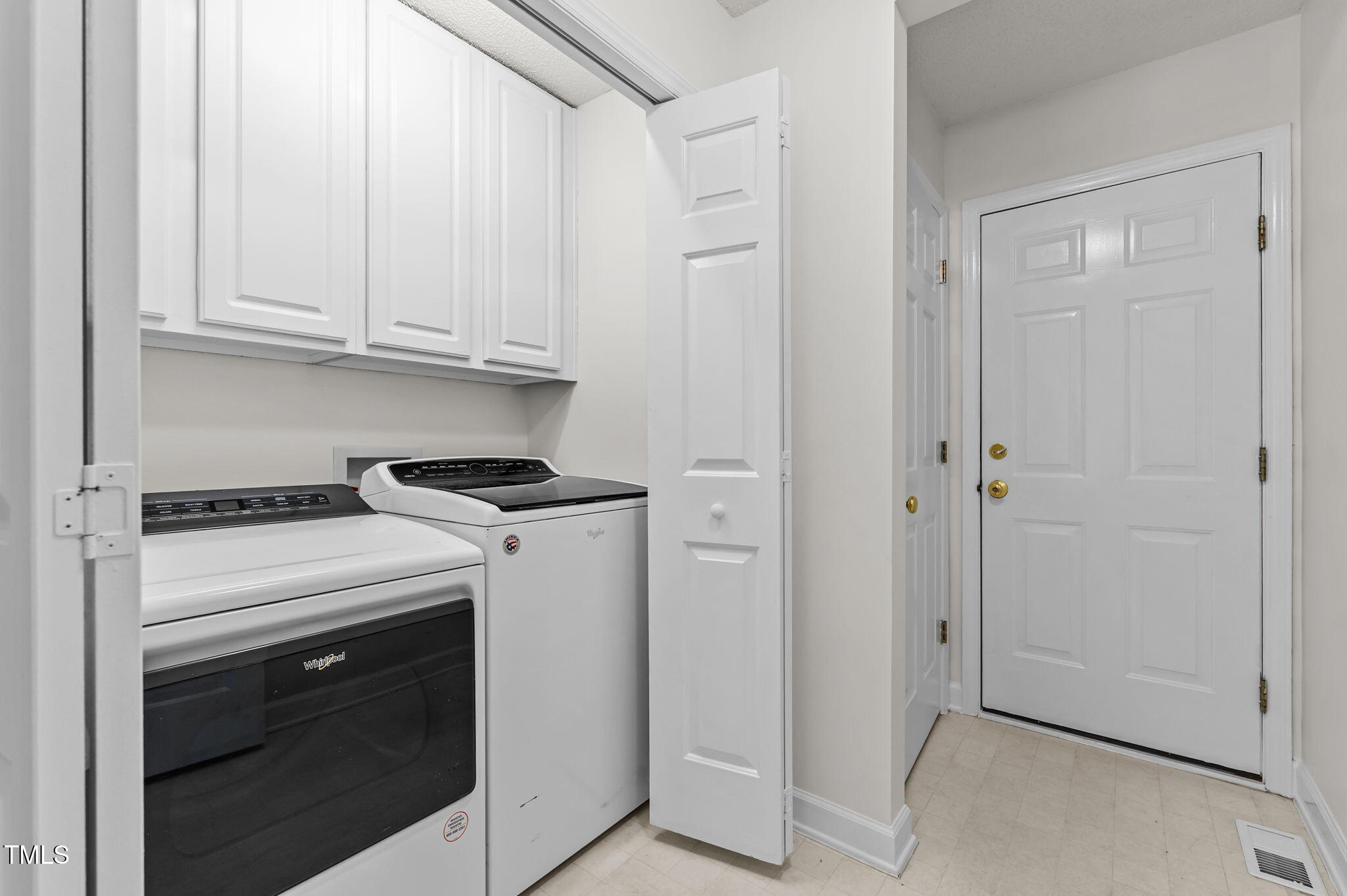11924 Larka Court Raleigh, NC 27613 - Photo 30 of 44 a view of washer and dryer with white cabinets