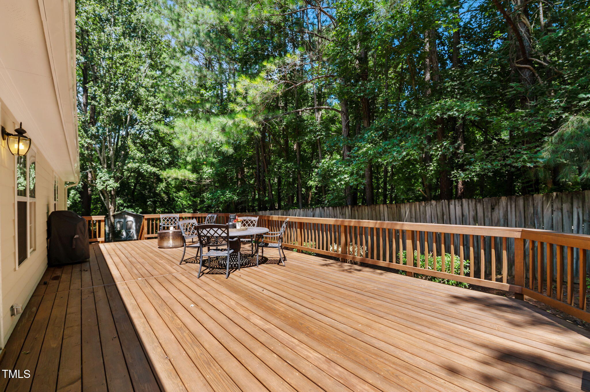 11924 Larka Court Raleigh, NC 27613 - Photo 32 of 44 a view of a patio with dining table and chairs with wooden floor