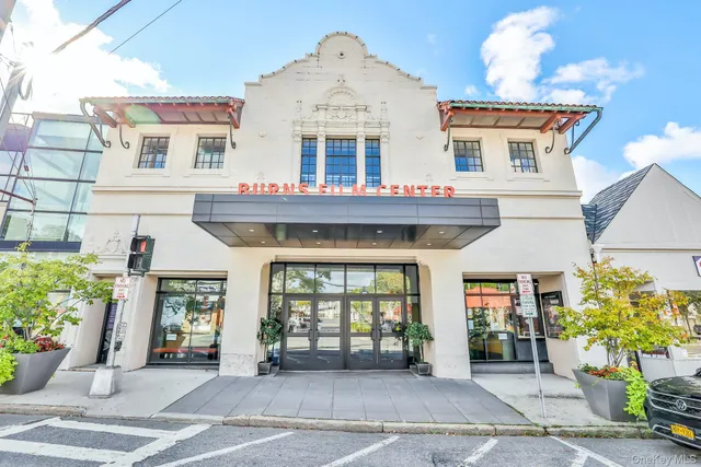 a front view of a building with potted plants