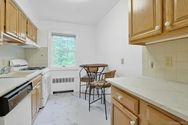 a view of a kitchen with a sink and cabinets