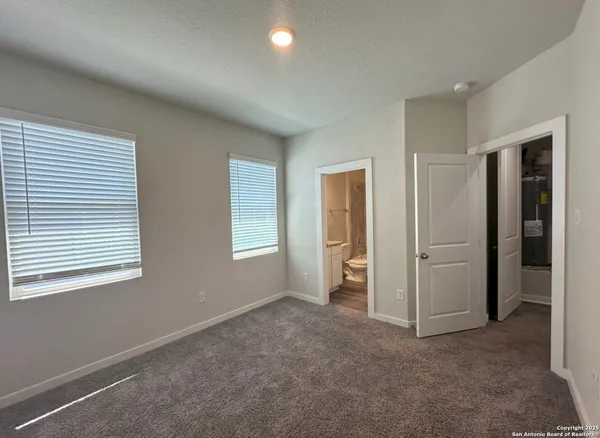 an empty room with windows and closet