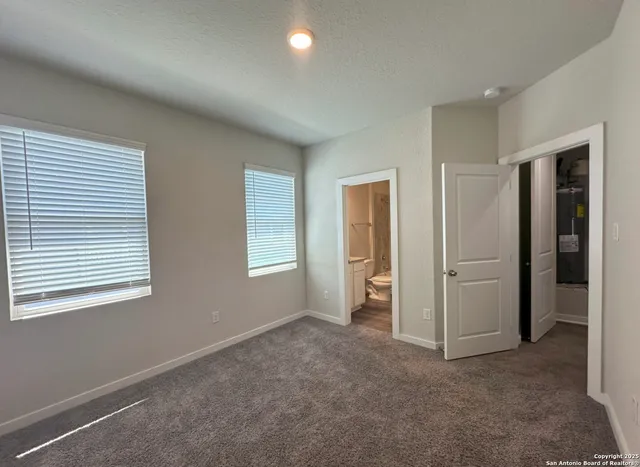 an empty room with windows and closet