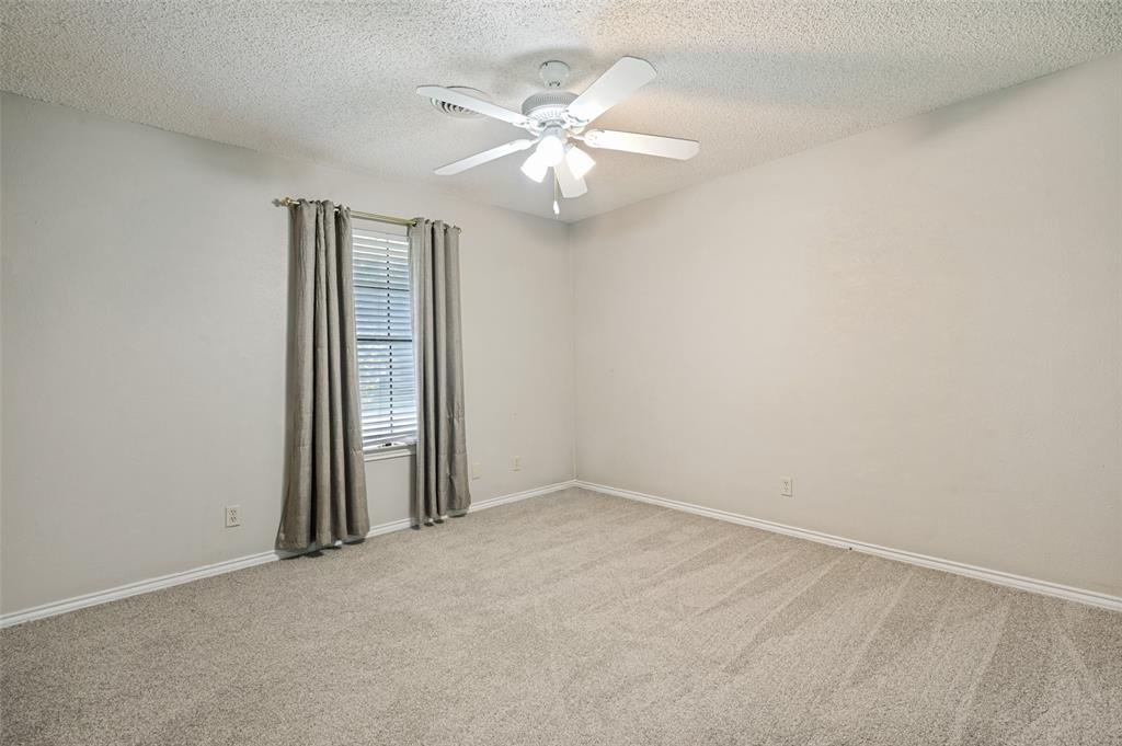 508 South Pedigo Street Pilot Point, TX 76258 - Photo 17 of 26 Bedroom with neutral tone walls, plush carpet flooring, and a ceiling fan with integrated lighting