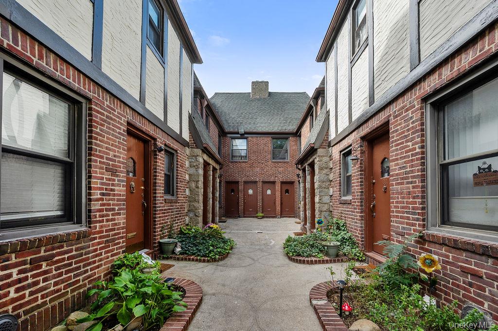 43-24 208th Street Queens, NY 11361 - Photo 2 of 14 a front view of a house with garden