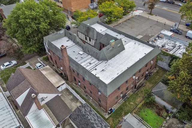 an aerial view of a house with a yard