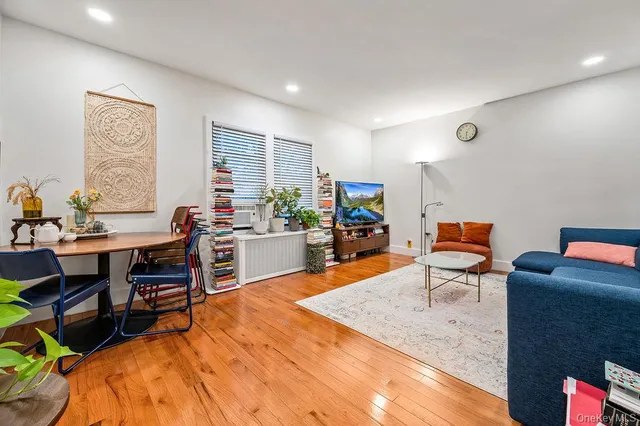 a work room with furniture a rug and a window