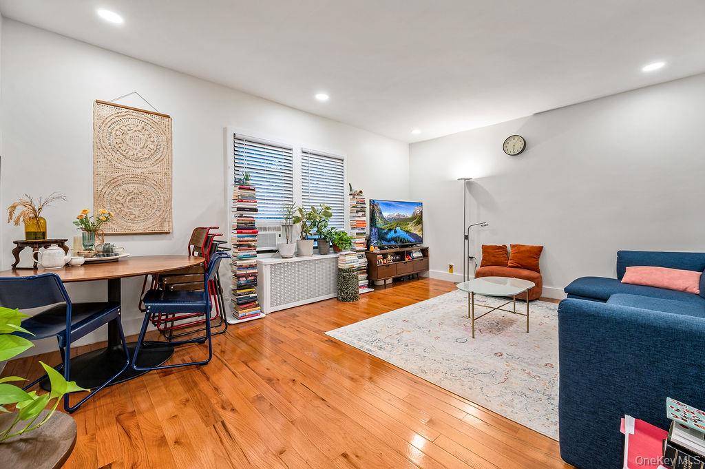 43-24 208th Street Queens, NY 11361 - Photo 5 of 14 a work room with furniture a rug and a window