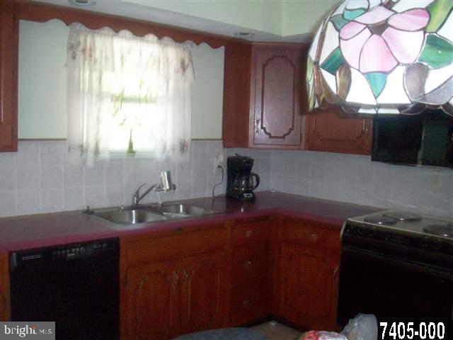 1780 Lilac Road York, PA 17408 - Photo 8 of 21 a kitchen with a sink a window and cabinets