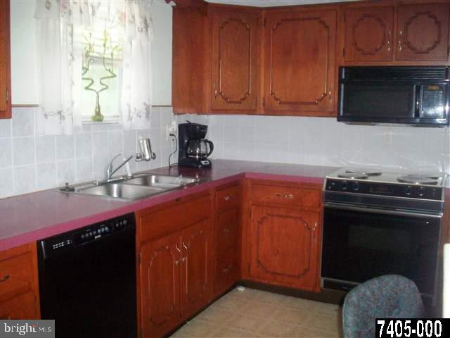 1780 Lilac Road York, PA 17408 - Photo 9 of 21 a kitchen with stainless steel appliances a stove a microwave a sink and cabinets