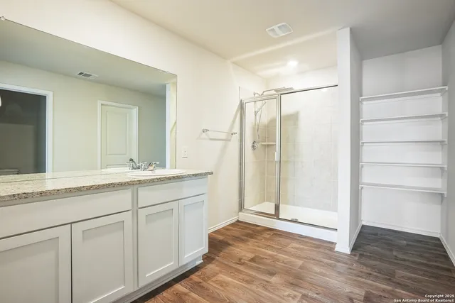 a view of kitchen with wooden floor and electronic appliances
