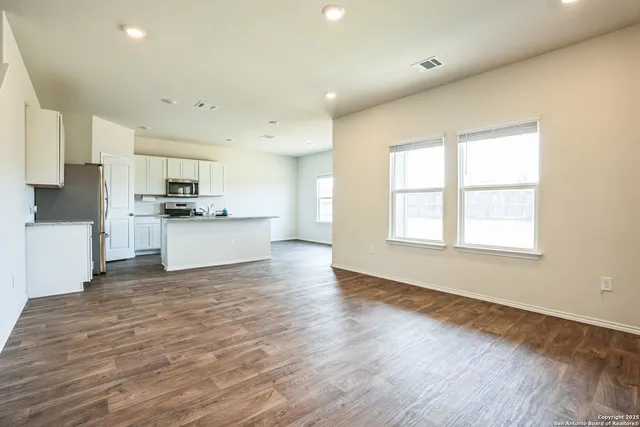 a view of a kitchen with a sink and cabinets