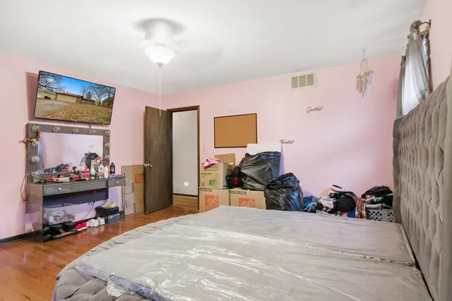 a bedroom with a bed and a chandelier