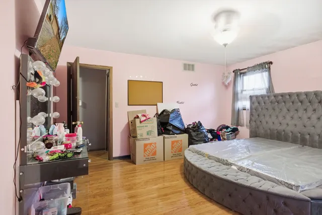 a bedroom with a bed couch and window