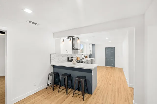 a kitchen with a stove and white cabinets