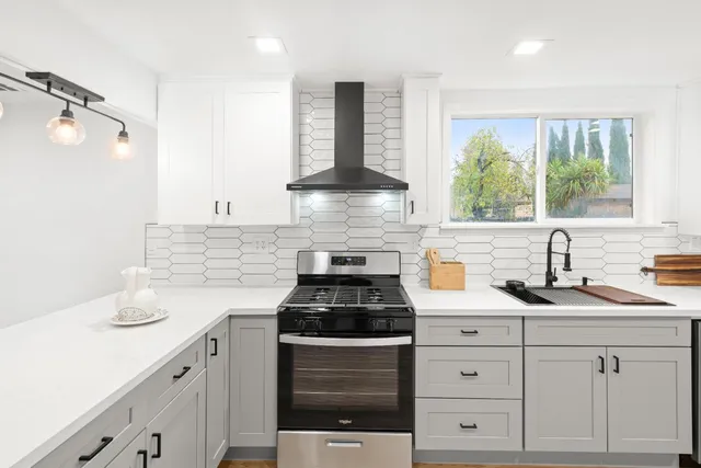a kitchen with white cabinets and appliances