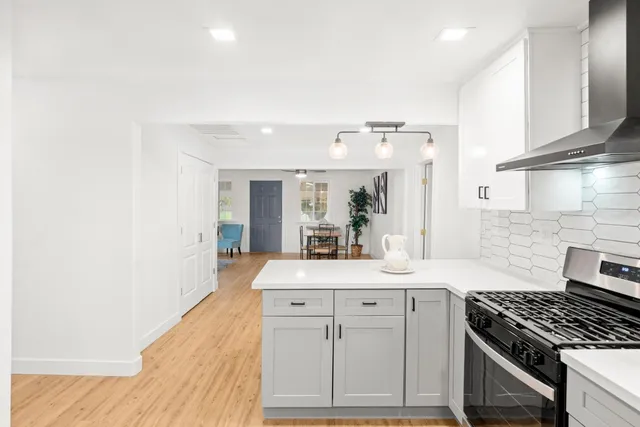 a view of a room with wooden floor and windows