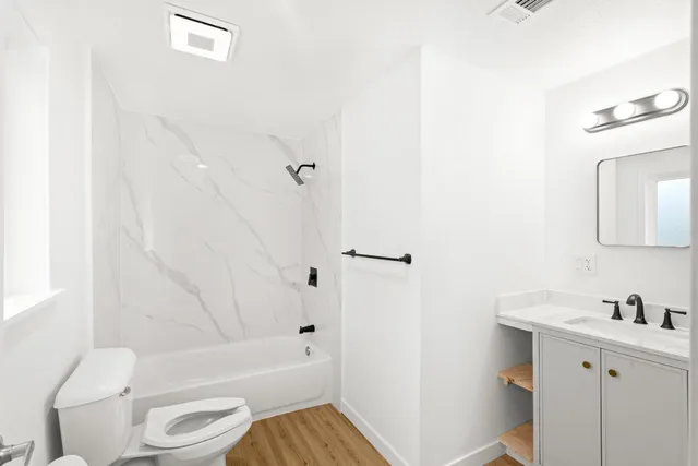 a bathroom with a sink a vanity and a mirror