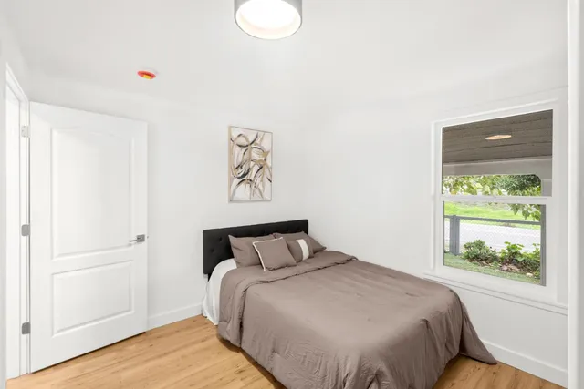 a spacious bedroom with a bed and a table