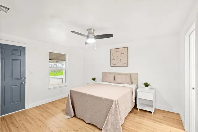 a bedroom with a bed and a window