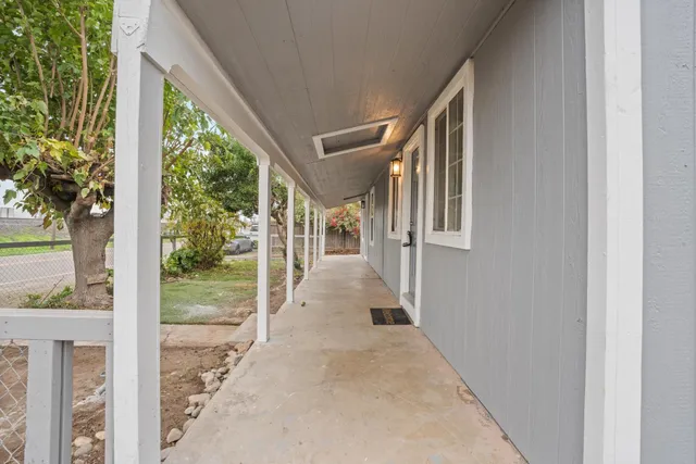 an aerial view of a house with a yard and a lake view