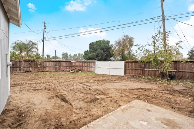 an aerial view of residential houses with outdoor space and river